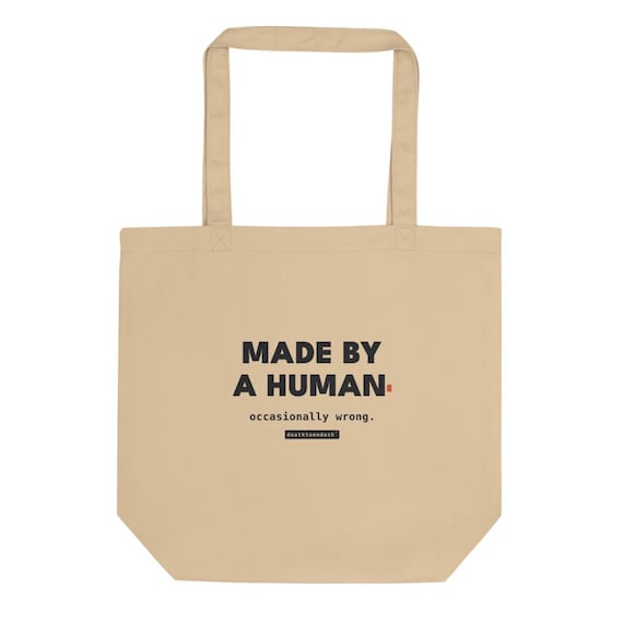 made by a human occasionally wrong tee, shown flat so the design reads
