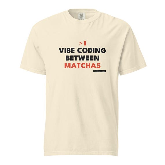 vibe coding between matchas tee, shown flat so the design reads