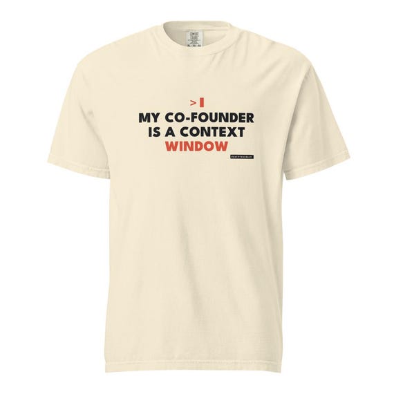 my cofounder is a context window tee, shown flat so the design reads